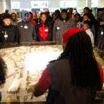 A group of students listens to a Microsoft staff