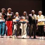 Black College Expo attendees standing on a stage.